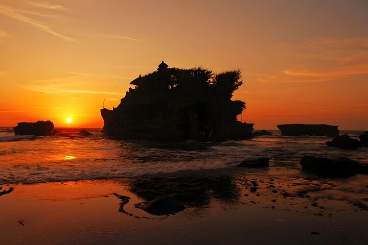Uluwatu Temple perched on a cliff edge at sunset in Bali